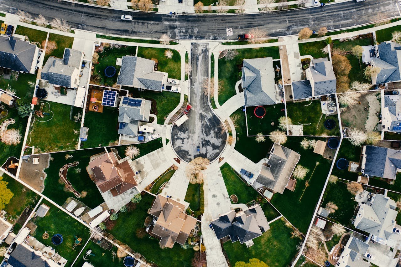 Aerial view showcasing a residential neighborhood in Herriman, Utah with modern architecture and green lawns.